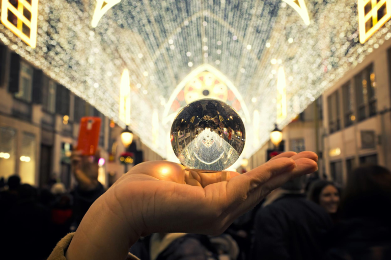 person holding round silver colored accessory