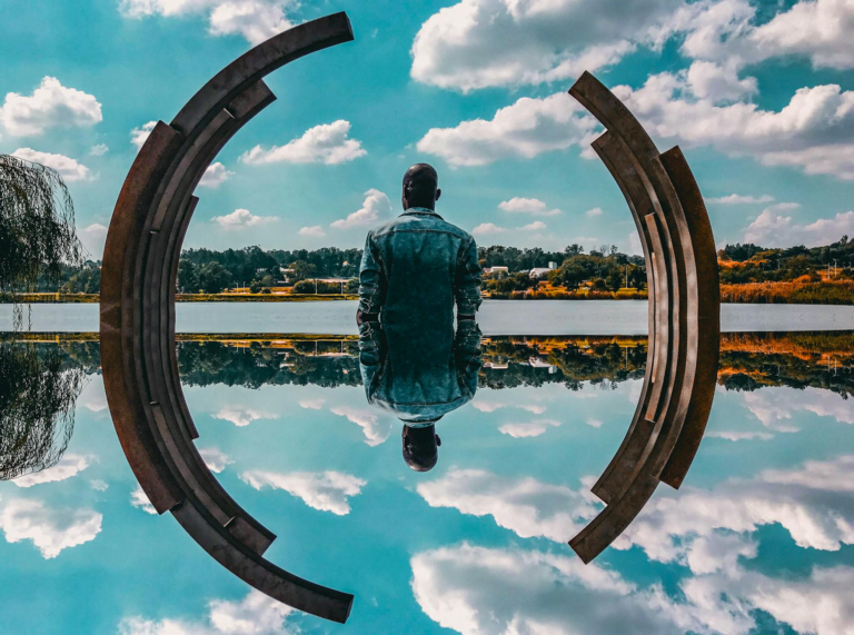 man standing near body of water
