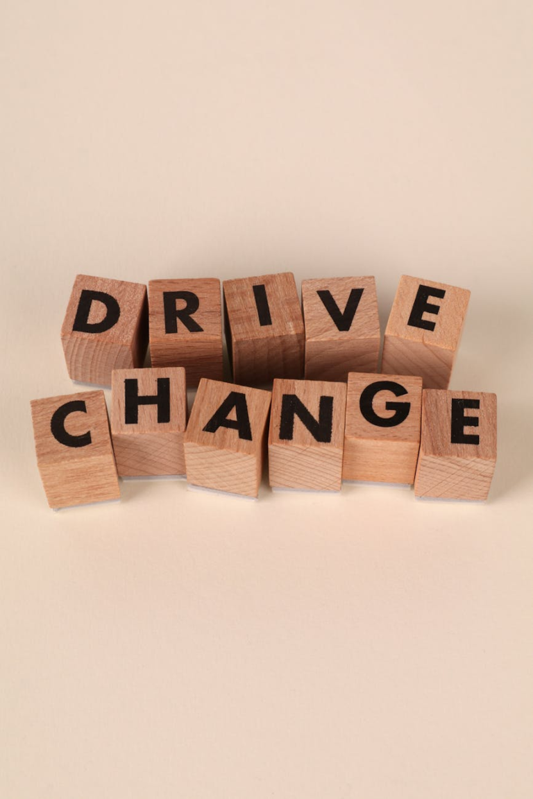 wooden blocks spelling drive change on beige background