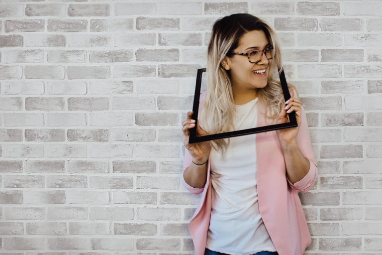 woman holding black photo frame